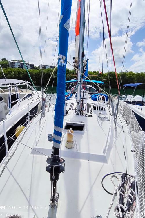 Sailboat deck view, Custom Patago 40, 2019 model, docked under a partly cloudy sky.