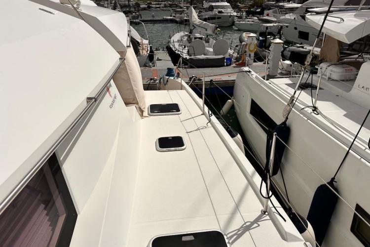2016 Fountaine Pajot Ipanema 58 catamaran docked at marina, showcasing deck and nearby boats.