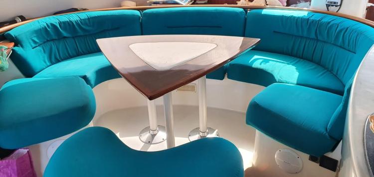 Interior of 1999 Fountaine Pajot Bahia 46 with turquoise seating and triangular table.