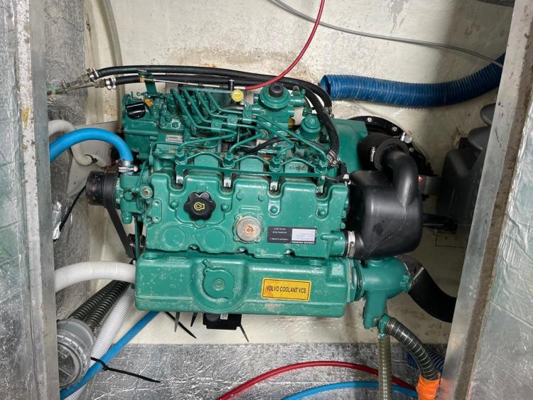 Engine compartment of a 2006 Fountaine Pajot Bahia 46 catamaran, featuring a green marine engine.