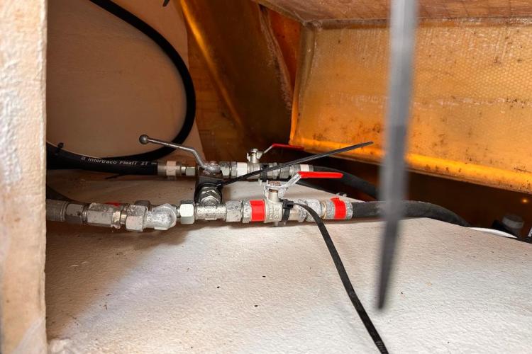 Engine compartment of 2016 Fountaine Pajot Ipanema 58 with visible piping and valves.