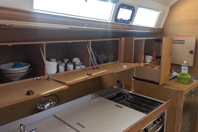 Modern kitchen interior of 2017 Dufour 460 Grand Large yacht with wooden cabinets.