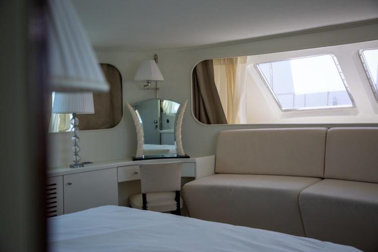 Luxurious interior of 1972 Benetti 33 yacht with elegant seating and vanity area.