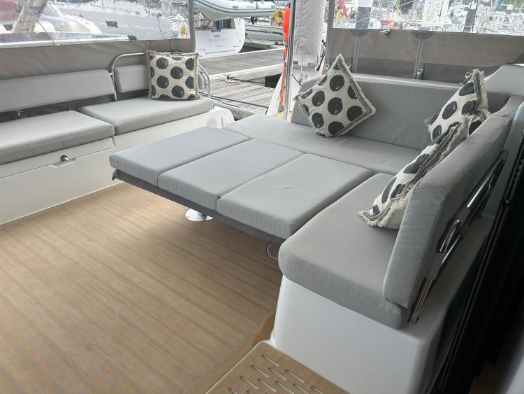 Luxurious seating area on 2024 Excess 14 yacht with modern cushions and sleek design.