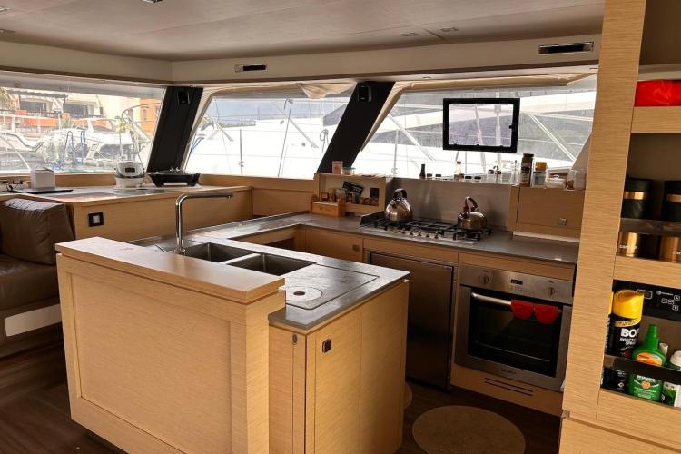 Luxurious kitchen interior of 2016 Fountaine Pajot Ipanema 58 catamaran with modern amenities.