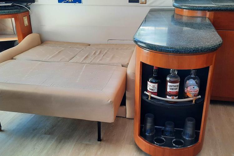 Interior of 2000 Carver 530 Voyager Pilothouse with sofa bed and bar area.