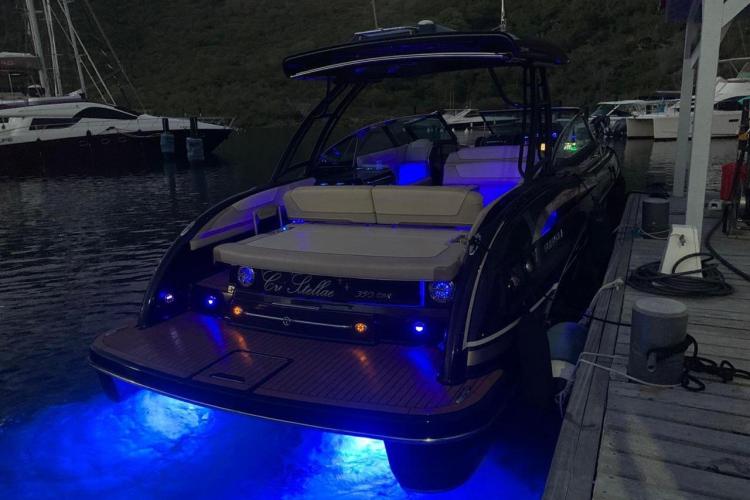 2018 Formula 350 Crossover Bowrider with blue LED lights docked at night.
