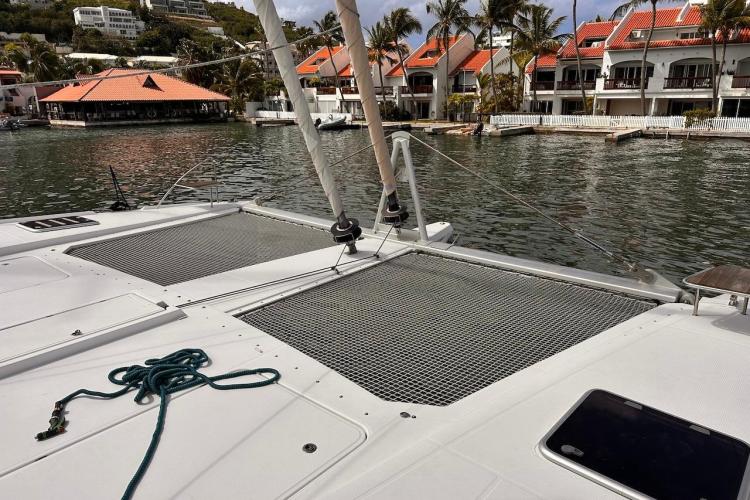 2016 Fountaine Pajot Ipanema 58 catamaran docked near waterfront villas.