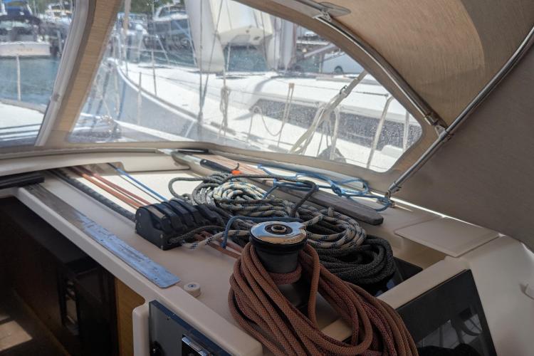 Cockpit view of 2017 Dufour 460 Grand Large sailboat with ropes and winch.