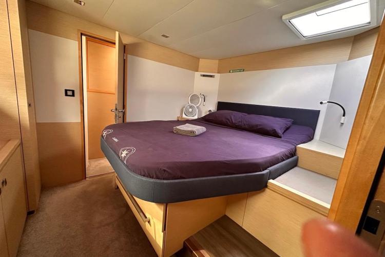 Luxurious cabin interior of 2016 Fountaine Pajot Ipanema 58 yacht with cozy bed.