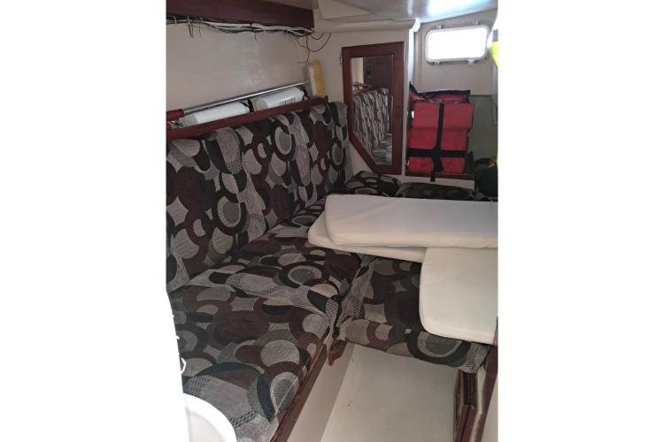 Interior of 1986 Dufour CATALINA sailboat with patterned seating and compact design.