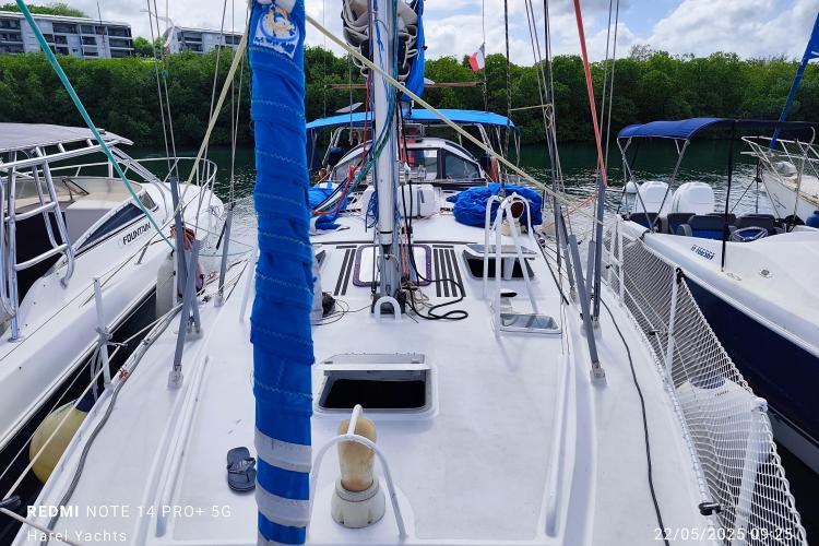 Sailboat docked in marina, Custom Patago 40, 2019 model, surrounded by other boats.