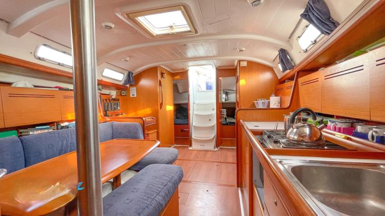 Interior of 2005 Beneteau Cyclades 43.3 yacht, featuring cozy seating and a well-equipped kitchen.