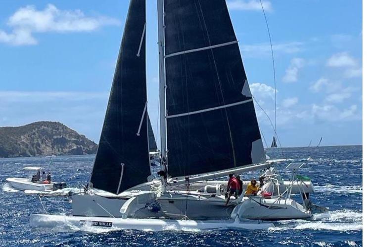 Sailing Coulombel Trimaran 1994 on blue ocean with clear sky background.