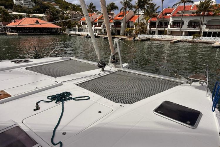 2016 Fountaine Pajot Ipanema 58 catamaran docked near waterfront villas.