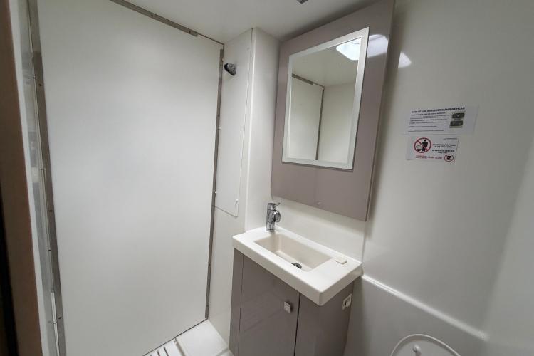 Bathroom interior of 2020 Fountaine Pajot Astrea 42 catamaran, featuring sink and mirror.
