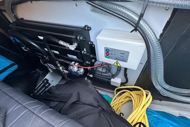Electrical system components in a 2023 Fountaine Pajot Elba yacht, featuring cables and control panel.