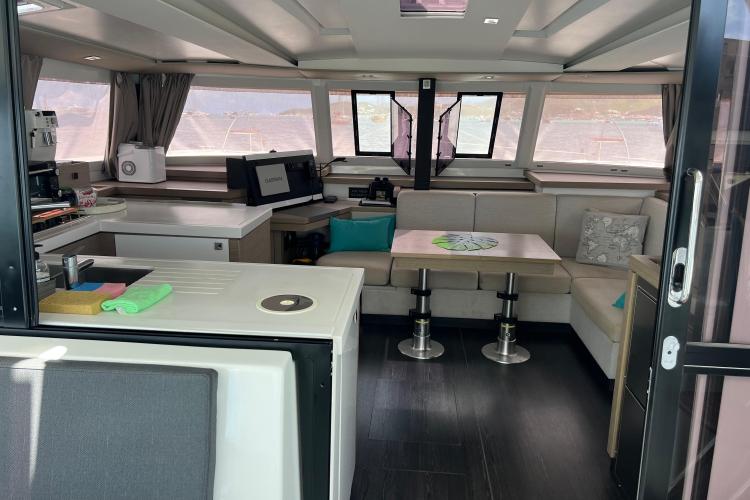 Interior of 2023 Fountaine Pajot Astrea 42 Catamaran, featuring modern kitchen and seating area.