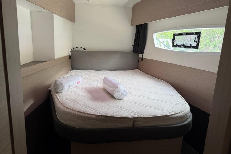 Cozy cabin interior of 2020 Fountaine Pajot Astrea 42 catamaran with comfortable bed.