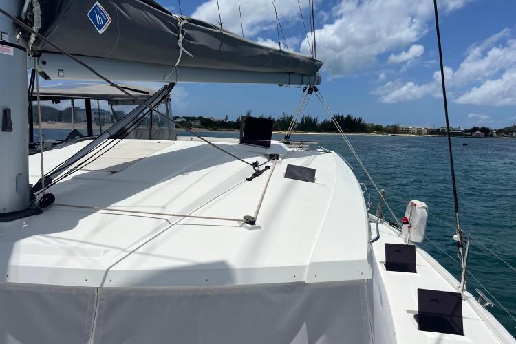 2023 Fountaine Pajot Astrea 42 Catamaran sailing on a sunny day near the coast.