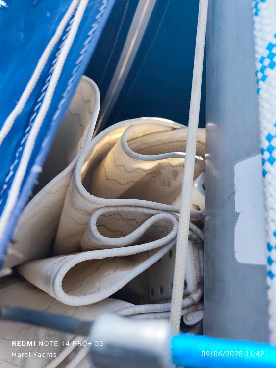 Rolled sail on a 2005 Beneteau Cyclades 43.3 yacht, close-up view.