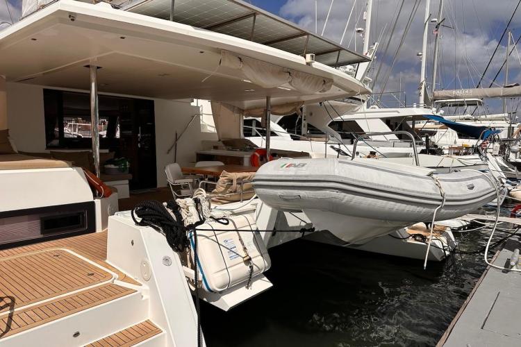 2016 Fountaine Pajot Ipanema 58 yacht docked with inflatable dinghy attached.