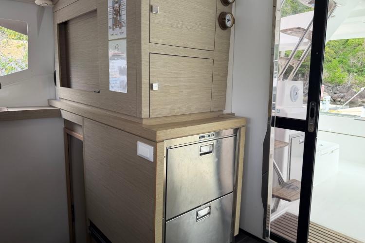 Interior of 2020 Fountaine Pajot Astrea 42 catamaran with modern cabinetry and stainless steel appliances.