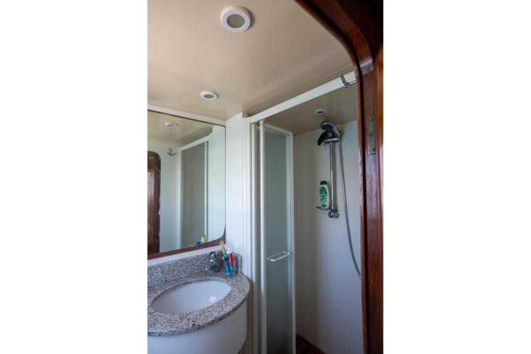 Bathroom interior of 1972 Benetti 33 yacht with shower and sink.
