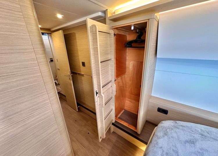 2023 Lagoon 46 yacht interior with open wooden closet and modern design.