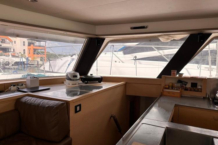 Interior view of 2016 Fountaine Pajot Ipanema 58 yacht with modern kitchen and large windows.
