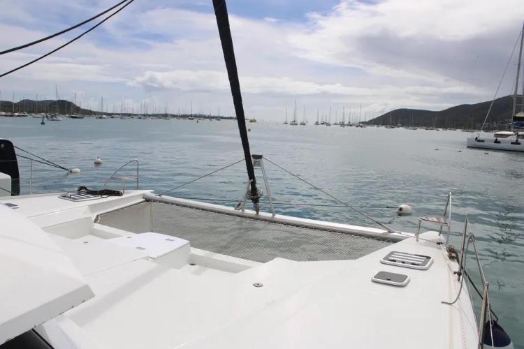 2017 Fountaine Pajot SABA 50 catamaran on calm waters with distant sailboats.