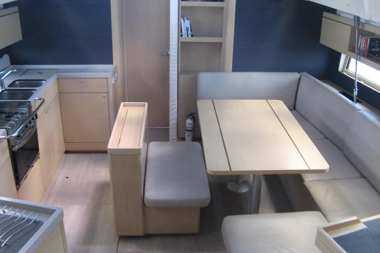 Interior of 2019 Beneteau Oceanis 46.1 yacht with modern kitchen and dining area.