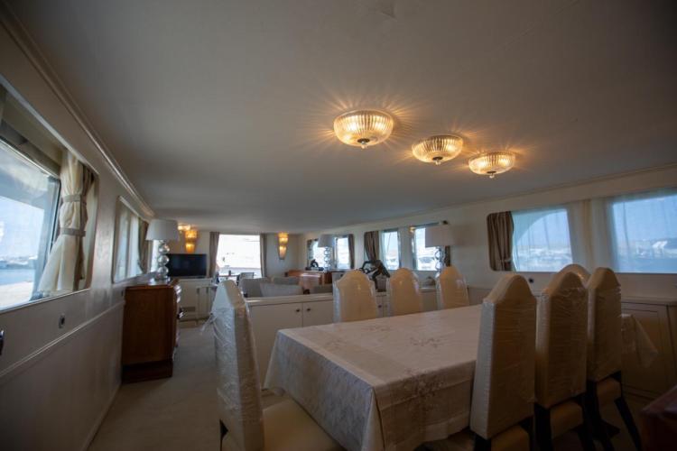 Interior of 1972 Benetti 33 yacht with elegant dining area and ambient lighting.