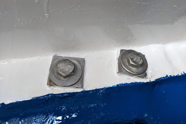 Close-up of bolts on a 2005 Beneteau Cyclades 43.3 sailboat hull.