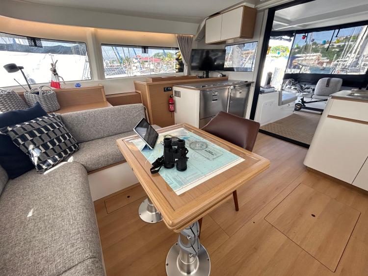Modern interior of 2024 Excess 14 yacht with cozy seating and navigation table.