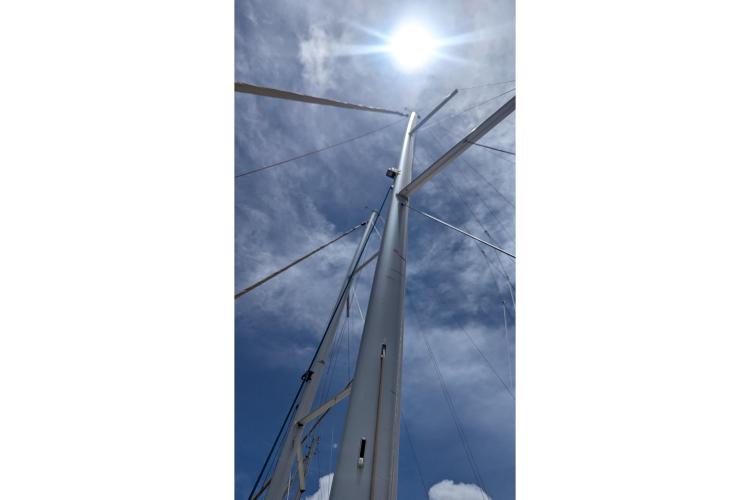 Mast of 2017 Dufour 460 Grand Large sailboat against a bright sky.