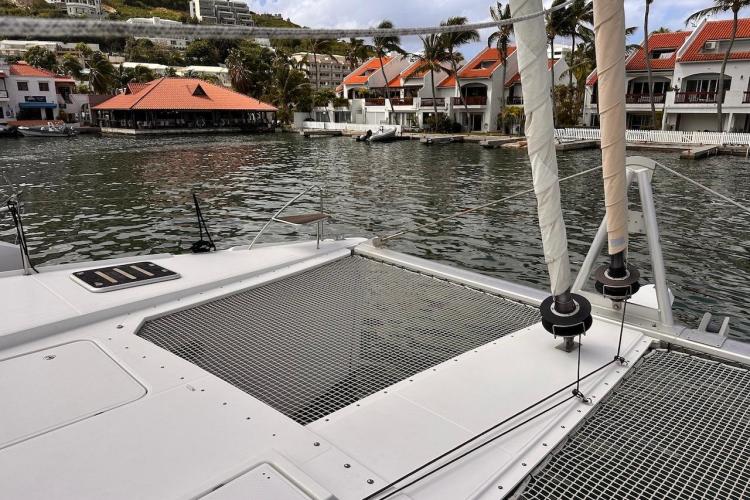 2016 Fountaine Pajot Ipanema 58 catamaran docked near waterfront homes.