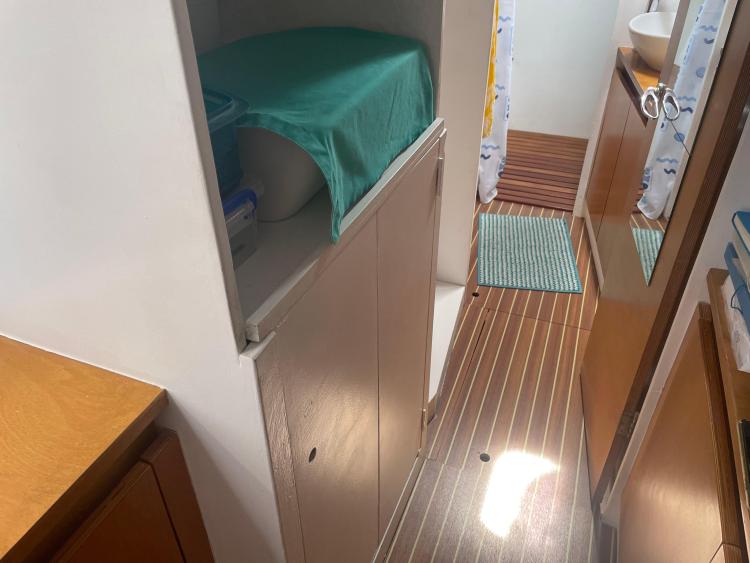 Narrow boat interior with wooden flooring, storage, and a small sink area. Custom KSENIA 149, 2010.