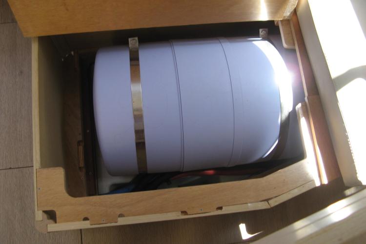 Storage compartment in a 2019 Beneteau Oceanis 46.1 yacht, featuring a secured cylindrical tank.