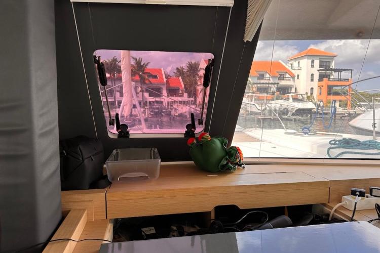 Interior view of 2016 Fountaine Pajot Ipanema 58 yacht with marina in background.