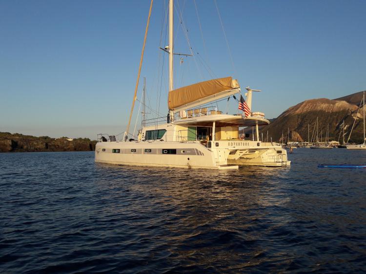 2019 Squalt Marine CK 64 yacht anchored in scenic bay with mountains in background.