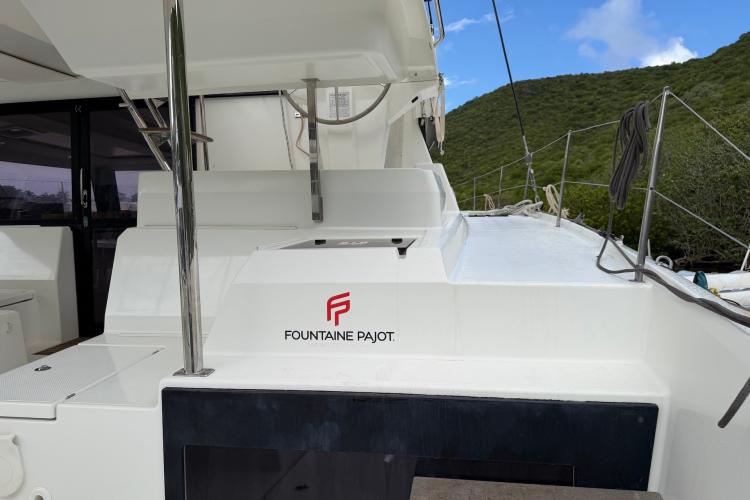 Fountaine Pajot Astrea 42 catamaran, 2020 model, docked with lush green hills in background.