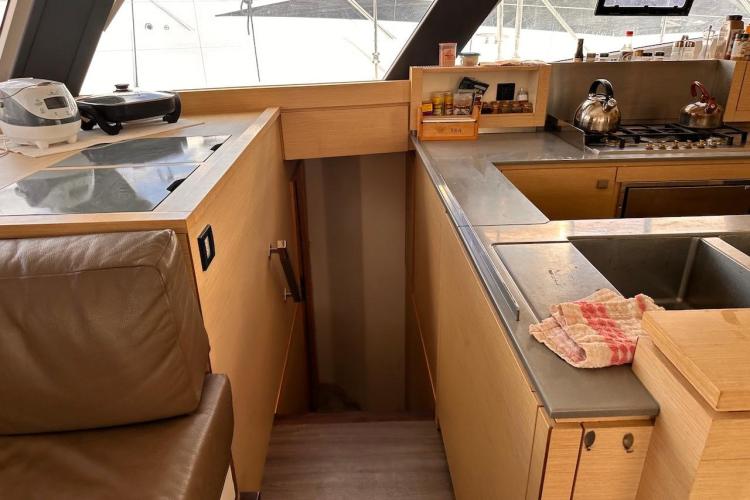 Modern kitchen interior of 2016 Fountaine Pajot Ipanema 58 yacht with sleek countertops.