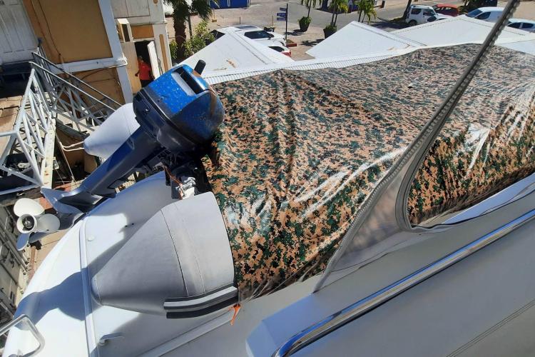 Inflatable boat with camouflage cover on Carver 530 Voyager Pilothouse, 2000 model.