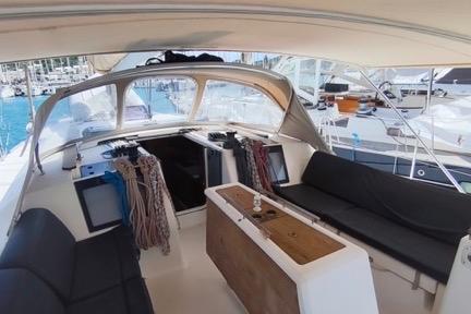 2017 Dufour 460 Grand Large yacht cockpit with seating and ropes, docked at marina.