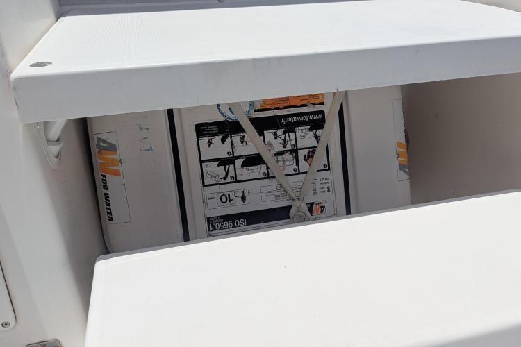 Storage compartment on 2017 Dufour 460 Grand Large yacht, featuring safety equipment.