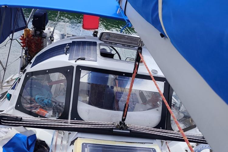 Custom Patago 40 sailboat cockpit with solar panels, blue canopy, and nautical equipment, 2019 model.