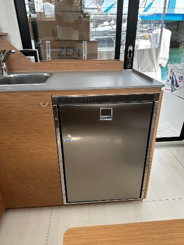 Modern kitchen area on 2024 Excess 11 yacht with stainless steel fridge.