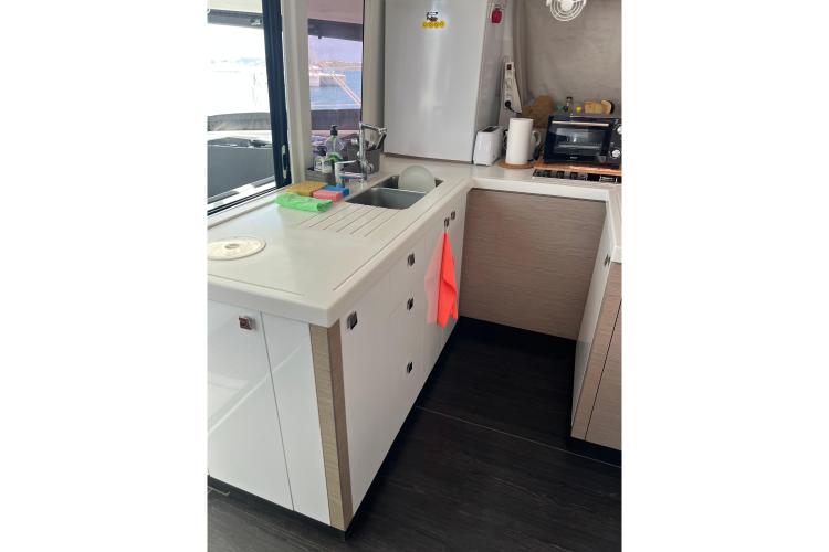 Modern kitchen interior of 2023 Fountaine Pajot Astrea 42 Catamaran with sink and appliances.