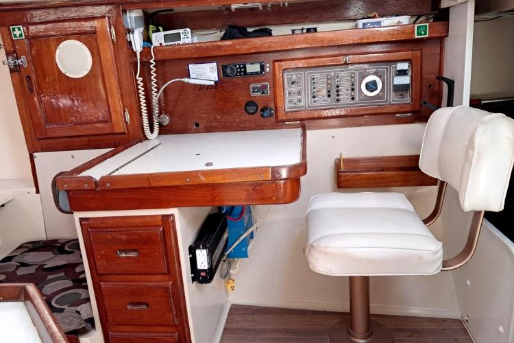 Interior of a 1986 Dufour CATALINA sailboat with navigation station and control panel.